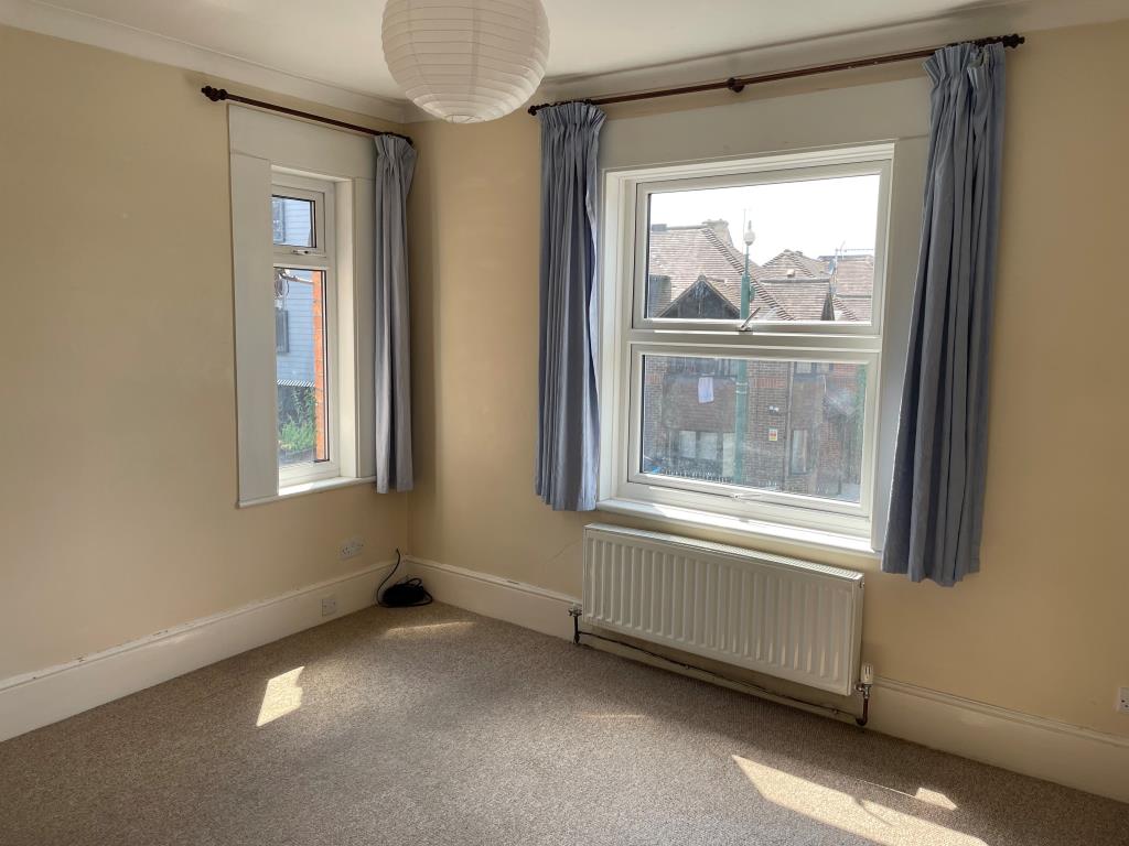 Lot: 139 - RETAIL UNIT AND WORKSHOP WITH GARAGE AND TWO FLATS - First floor main front bedroom with double aspect